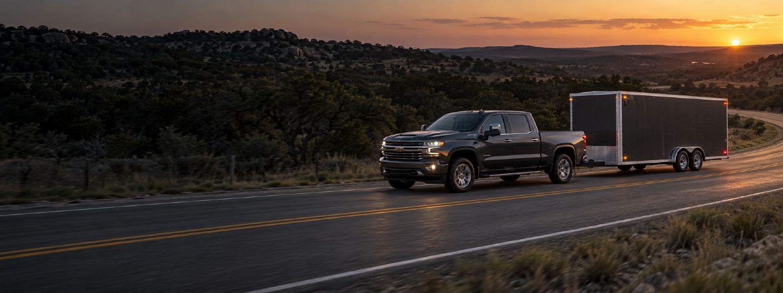Truck towing an enclosed trailer at dusk